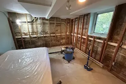 Walls opened to the studs with plastic sheeting and a wet vacuum during drying
