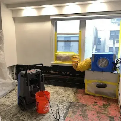 Wet ceiling drywall and attic insulation removed after a storm roof leak
