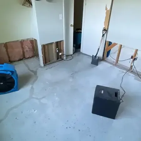 Water damage restoration in Ham Lake: air movers drying a stripped room