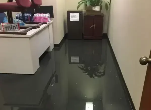 Standing water across the floor of an office reception area