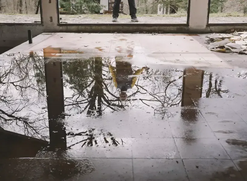 Floodwater standing on a tile floor in a lower level after a storm